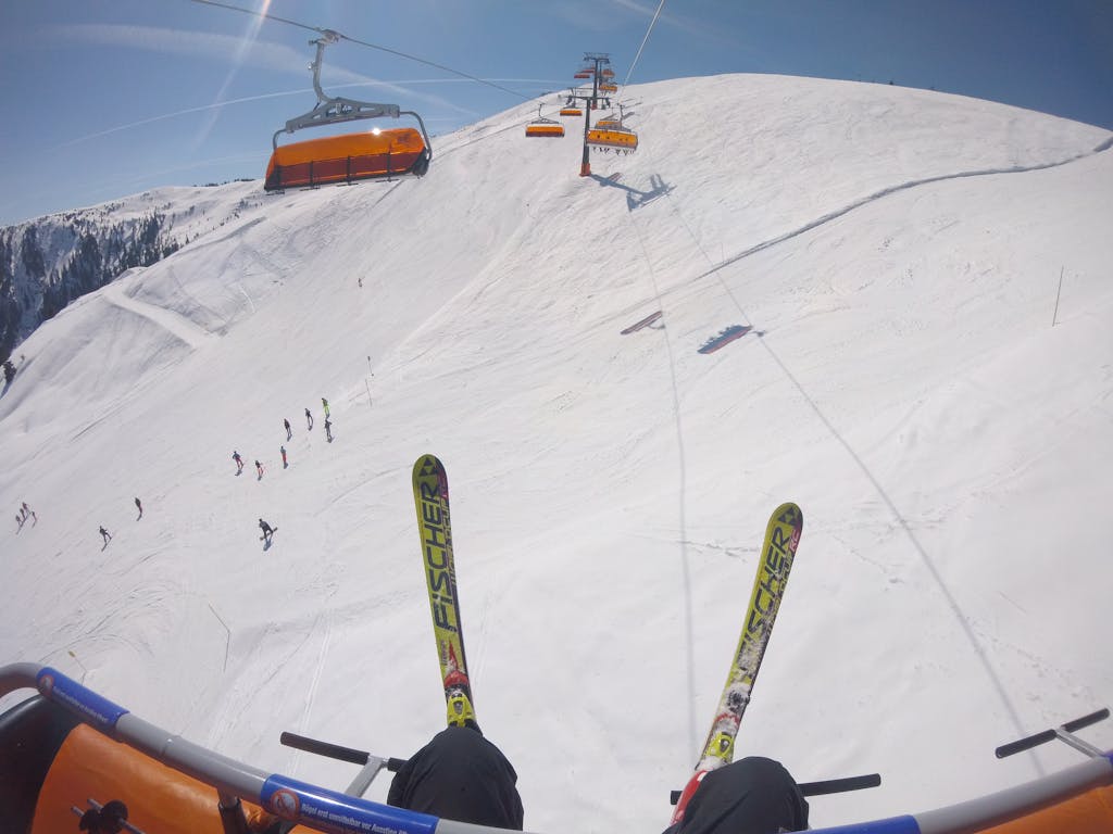 Person Wearing Snow Ski Riding A Cable Car